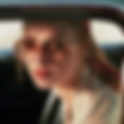 Image for The lady in the car with glasses and a gun